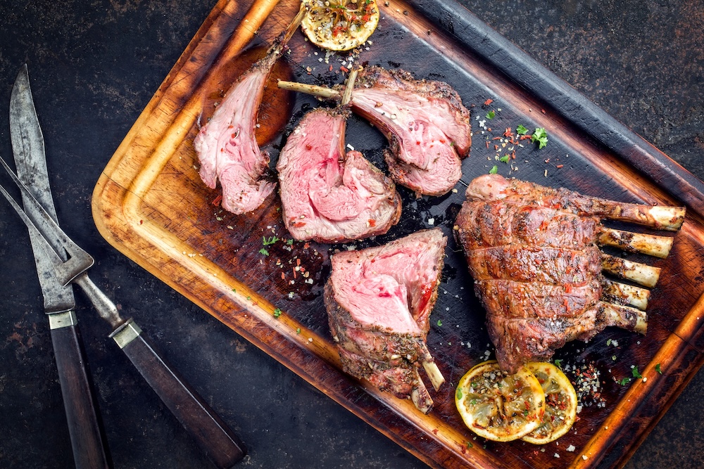 Barbecue veal loin as top view on burnt cutting board