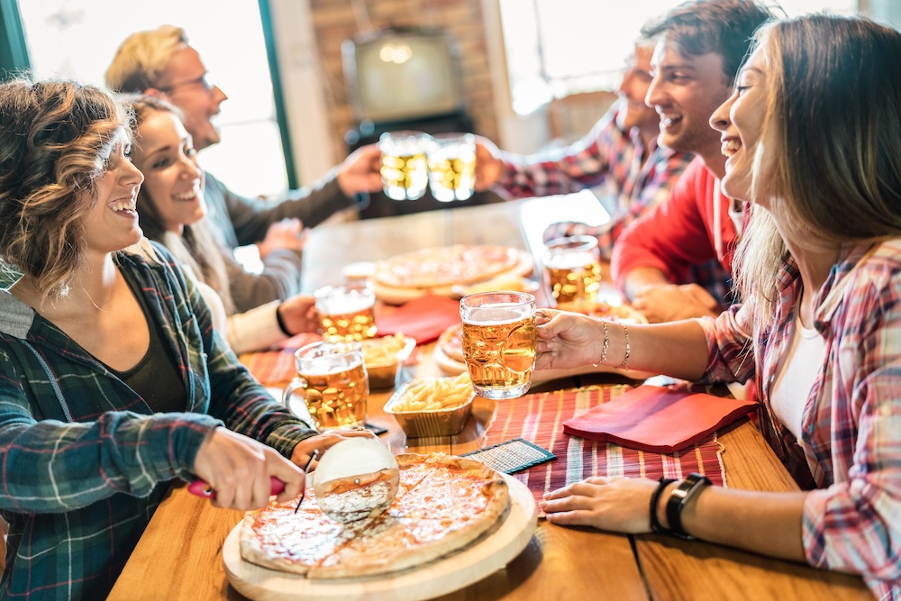 Young friends eating pizza. Young friends eating pizza.